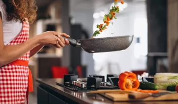 woman-chef-cooking-vegetables-pan-960x640